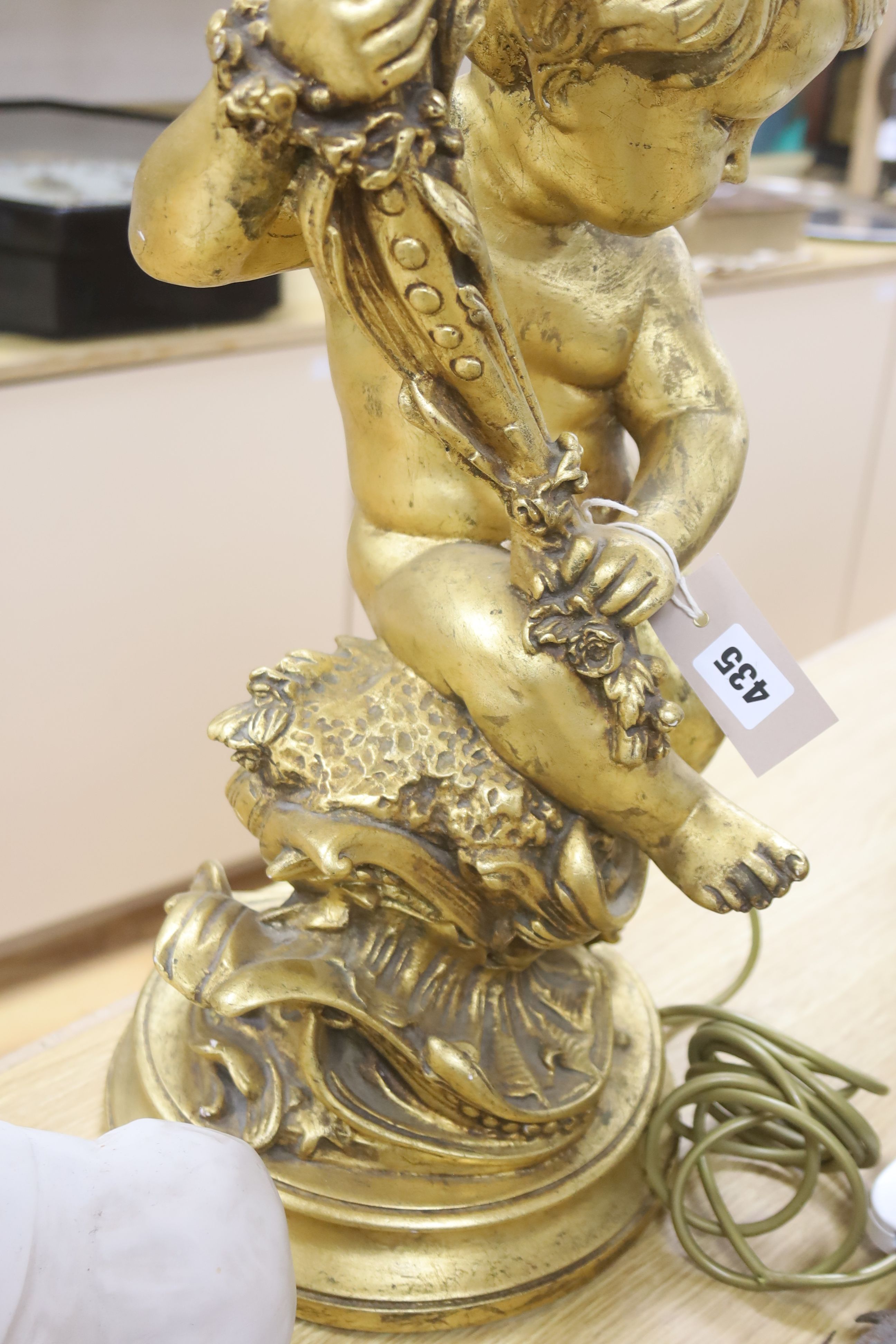 A large moulded gilt putti table lamp, height 70cm excl. light fitting